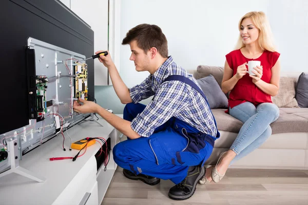 depositphotos 137860252 stock photo technician repairing television at home (2)